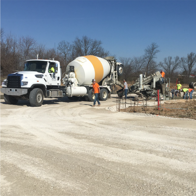 MoCon of Fulton inc cement mixing truck with crew at worksite